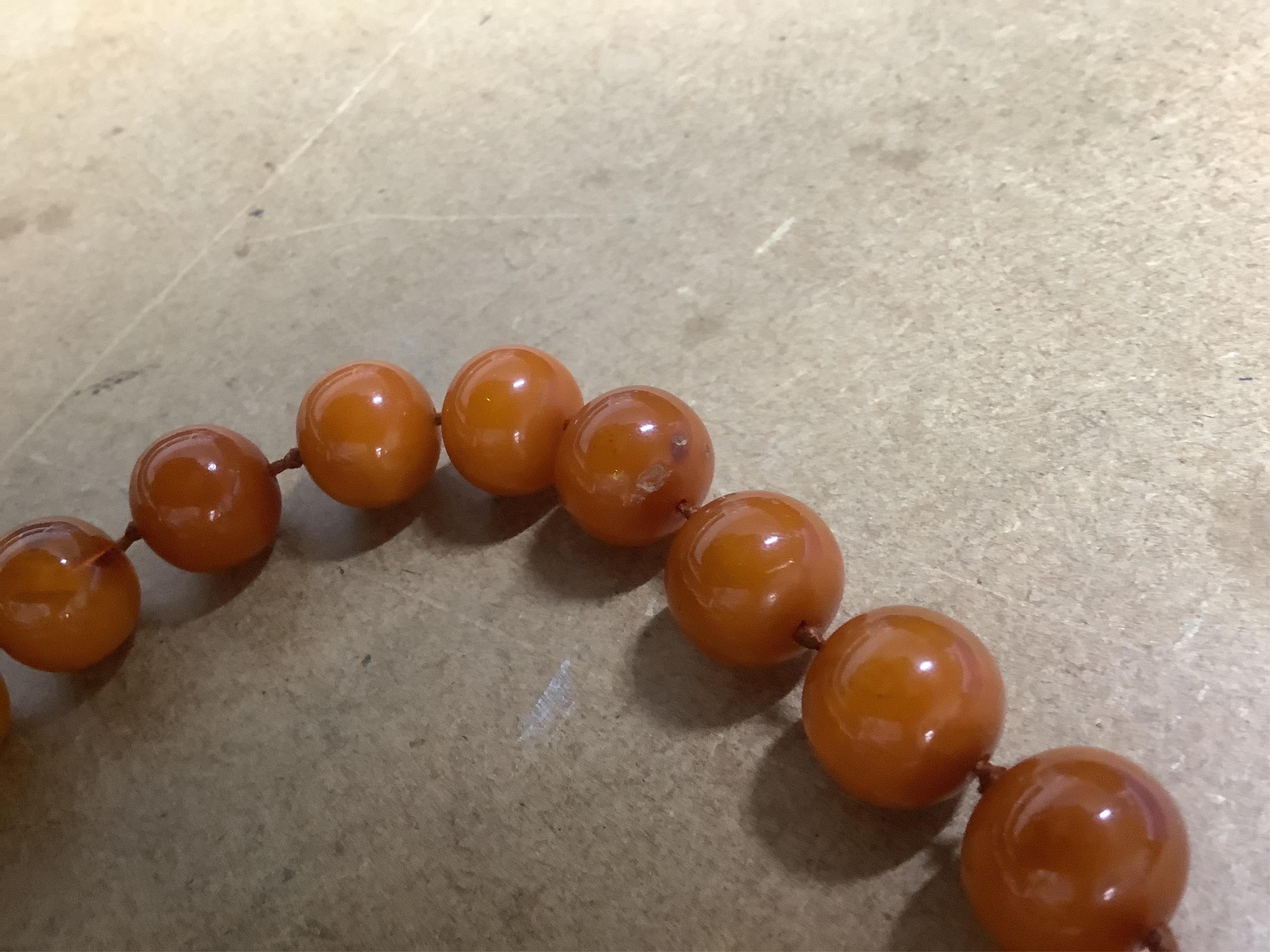 A single strand circular amber bead necklace, 56cm, gross weight 55 grams.